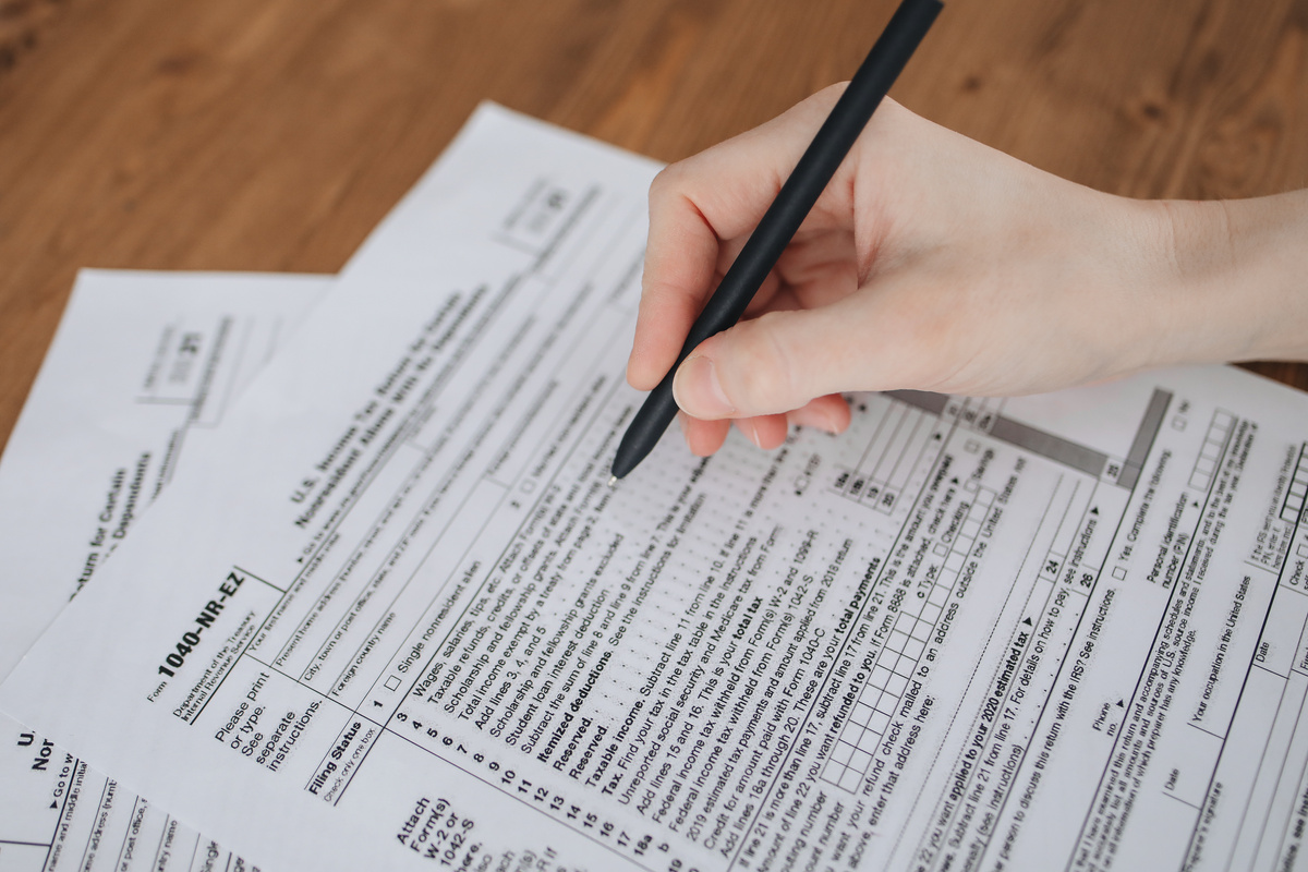 A Person Filling Out Taxation Documents